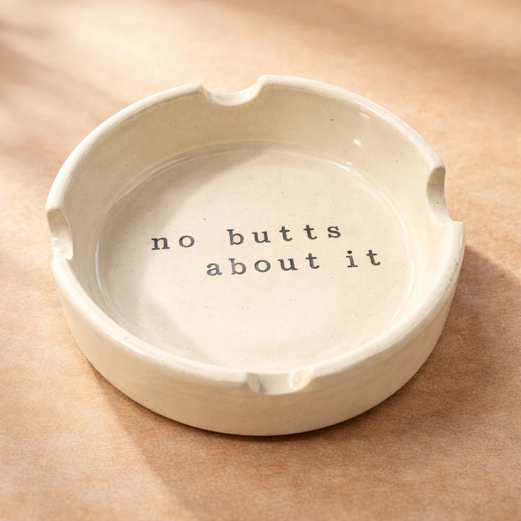 Ashtray featuring a quirky message that says 'no butts about it', handcrafted ceramic design.